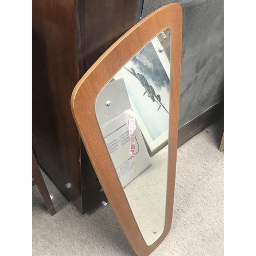 1334 - An Art Deco design wall mirror. 73cm long.