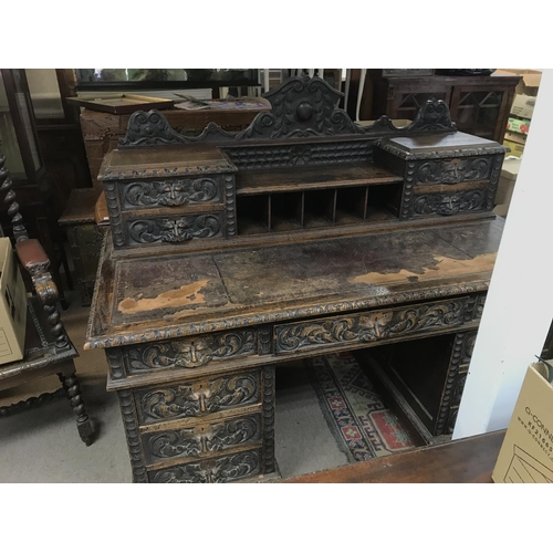 1353 - A Late Victorian oak carved desk with leather top, dimensions 75x152x126cm