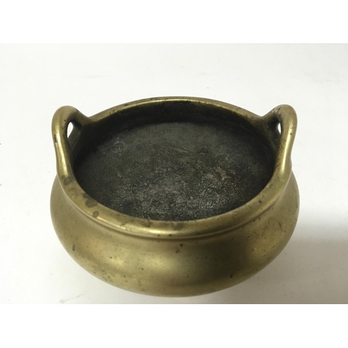 808 - A 19th century Chinese brass open censer with raised loop handles tripod base with impressed cast ca... 