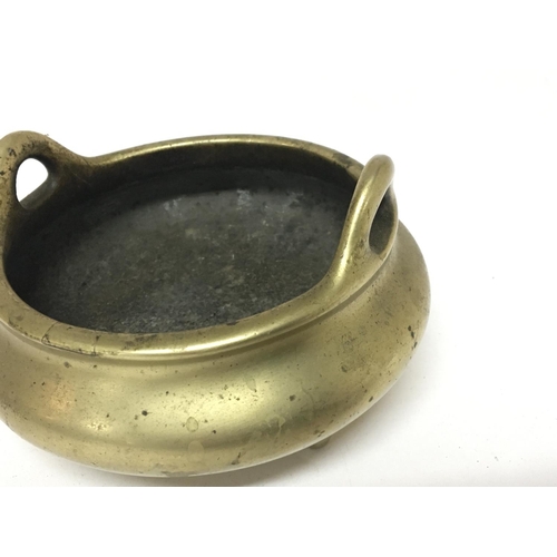 808 - A 19th century Chinese brass open censer with raised loop handles tripod base with impressed cast ca... 