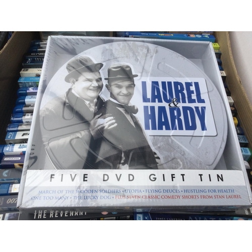 152 - Two boxes of BluRays and DVDs plus a sealed Laurel & Hardy DVD gift tin.