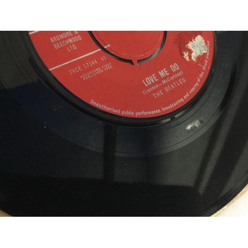 30 - A first UK pressing of 'Love Me Do' by The Beatles, tear to A Side label.