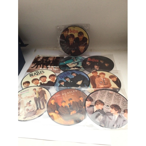 32 - A record case of Beatles EPs and picture discs, including both original releases and reissues.