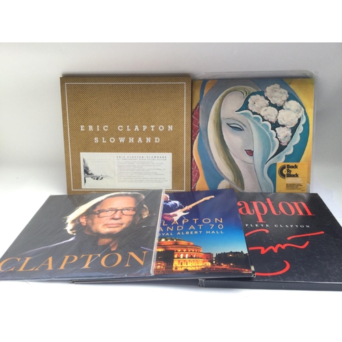 373 - Two bags containing five Eric Clapton LPs comprising a 'Slowhand' 35th anniversary super deluxe box ... 