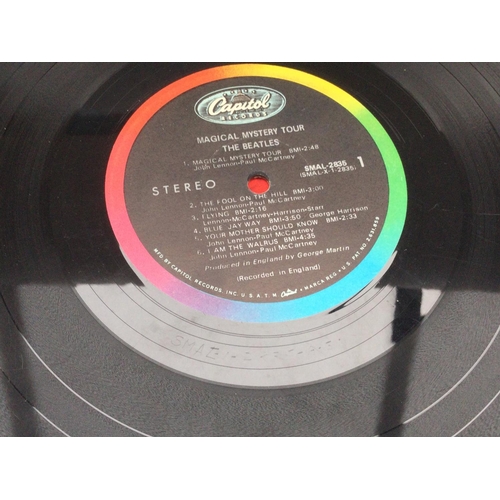 81 - Three Beatles LPs comprising a US pressing of 'Magical Mystery Tour', no sleeve and feelable scratch... 