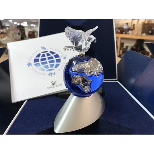 1089 - A boxed Swarovski Planet Vision 2000 figure of the globe surmounted by a Dove carrying an Olive Bran... 