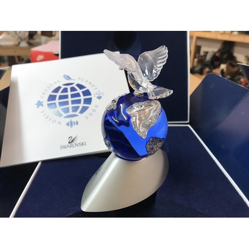 1089 - A boxed Swarovski Planet Vision 2000 figure of the globe surmounted by a Dove carrying an Olive Bran... 