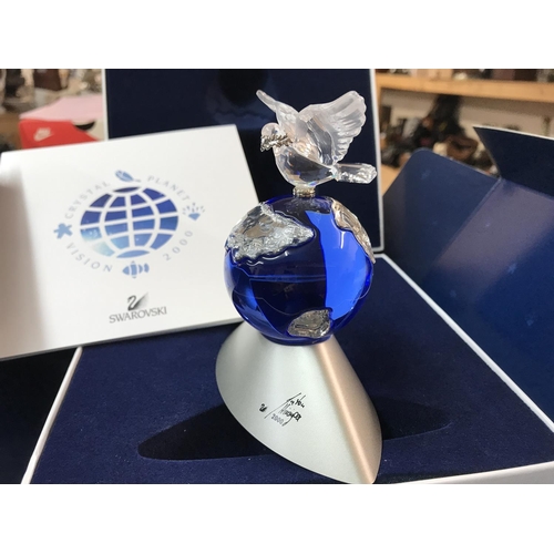 1089 - A boxed Swarovski Planet Vision 2000 figure of the globe surmounted by a Dove carrying an Olive Bran... 