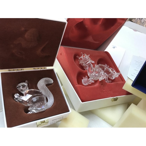 1101 - Four boxed Swarovski figures including Pearl Dragon, Unicorn, large squirrel and seahorses