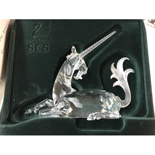 1101 - Four boxed Swarovski figures including Pearl Dragon, Unicorn, large squirrel and seahorses