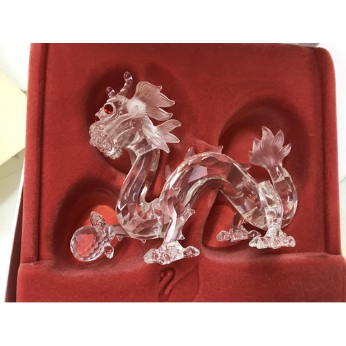 1101 - Four boxed Swarovski figures including Pearl Dragon, Unicorn, large squirrel and seahorses