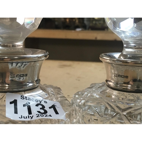 1131 - A pair of cut glass decanters with detachable stoppers and silver collars