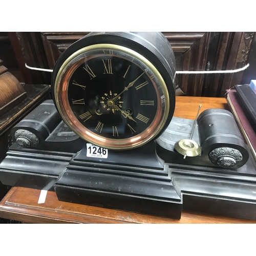 1246 - A Victorian slate mantle clock of classical form the circular dial with Roman numerals, with pendulu... 