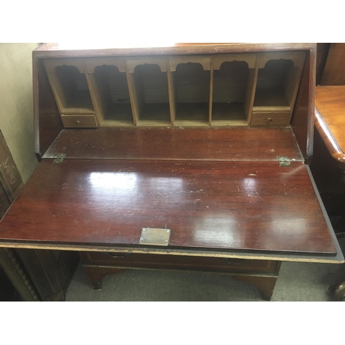 1248 - An Edwardian inlaid Mahogany bureau with a well fitted interior above three drawers.