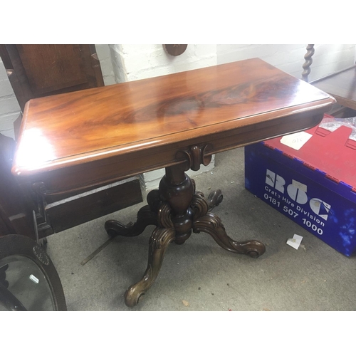 1253 - A Victorian mahogany card table with a hinged top on a bulbous column and splayed legs.