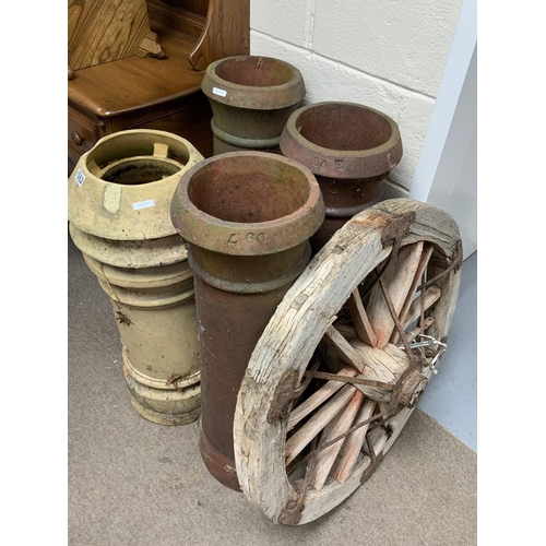 1262 - 4 Vintage terracotta chimney pots together with a wagon wheel. (D).