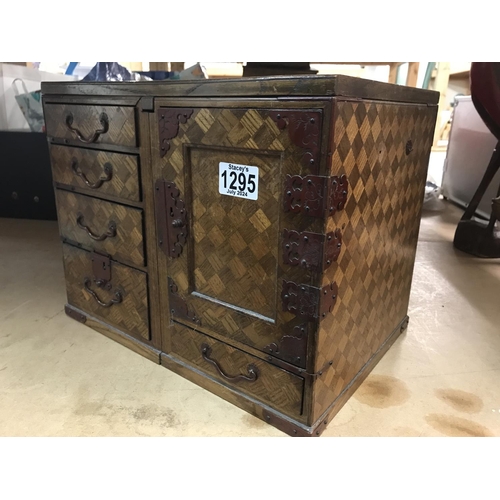 1295 - A parquetry collectors cabinet fitted with 5 drawers, single door enclosing 2 further drawers with a... 