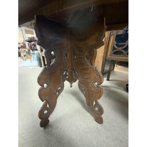 1312 - A carved eastern folding table. (D)