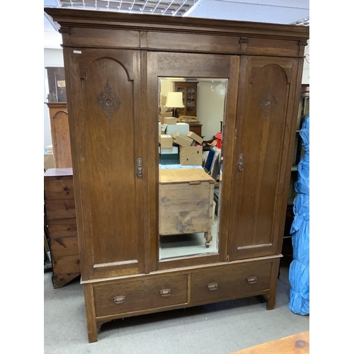 1319 - A Large 1050s oak triple wardrobe. 147cm x 212cm.