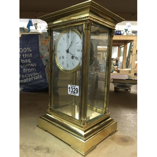 1329 - A French four glass brass mantle clock with visible mercury pendulum, the circular dial having Roman... 