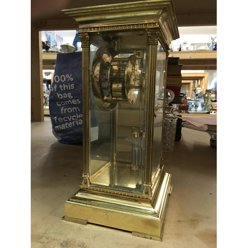 1329 - A French four glass brass mantle clock with visible mercury pendulum, the circular dial having Roman... 