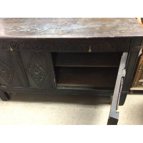 1334 - A carved oak 18th century or earlier with carved front and hinged rectangular top. With later later ... 