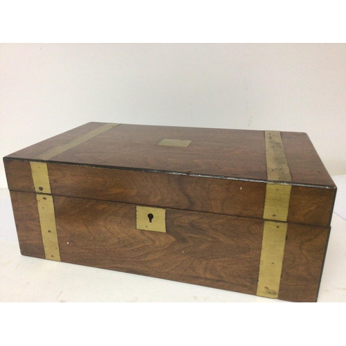 1336 - A Victorian walnut and brass bound writing slope with a well fitted interior.