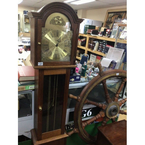 1341 - A Mahogany longcase clock with a brass dial and visible brass weights.