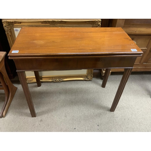 1353 - A Georgian Mahogany folding card table with square receded legs. 88.5cm x 42cm x 75cm.