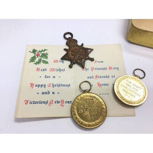 1554 - A family group of World War One medals including a 1914-15 star with a Christmas tin and card. Medal... 