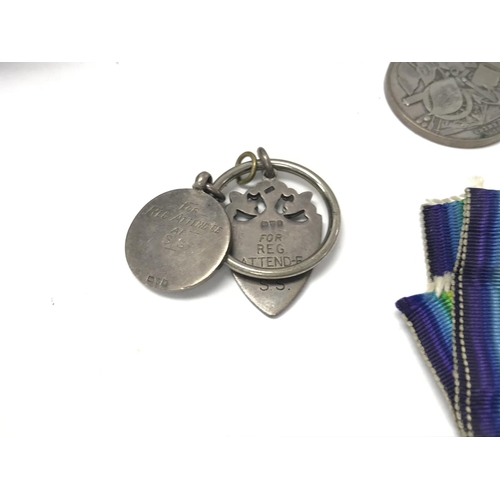 1555 - A collection of assorted medals and badges including a 9ct gold example. Lot including book with som... 