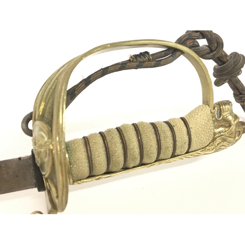 1579 - A 19th Century British Naval officers sword with leather scabbard. 32 Inch ornately decorated blade ... 