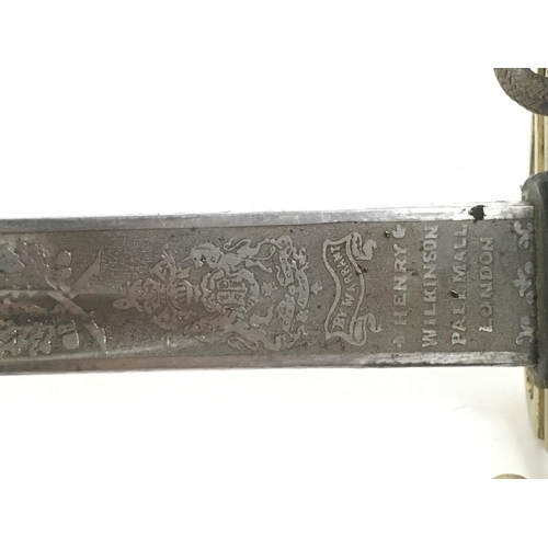 1579 - A 19th Century British Naval officers sword with leather scabbard. 32 Inch ornately decorated blade ... 