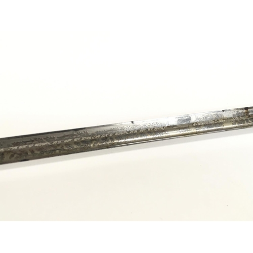 1579 - A 19th Century British Naval officers sword with leather scabbard. 32 Inch ornately decorated blade ... 