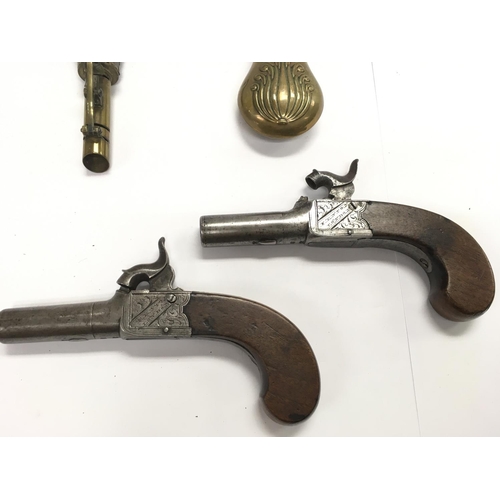 1589 - A pair of English percussion cap pistols with walnut grips. Marked Fenton London. Also two powder fl... 