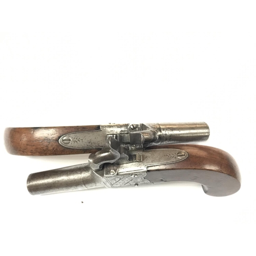 1589 - A pair of English percussion cap pistols with walnut grips. Marked Fenton London. Also two powder fl... 