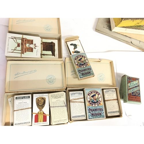 1668 - A collection of Players and Wills cigarette cards in sets and packets. Postage category C