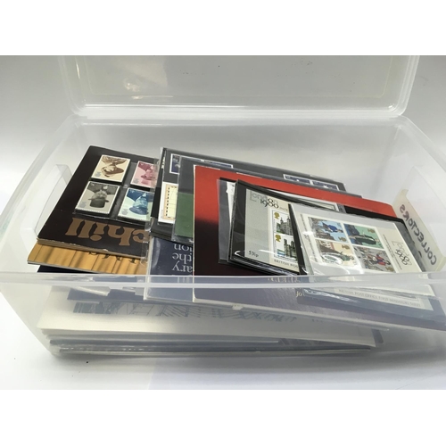 1708 - 13 albums of great Britain presentation packs together with one plastic container.