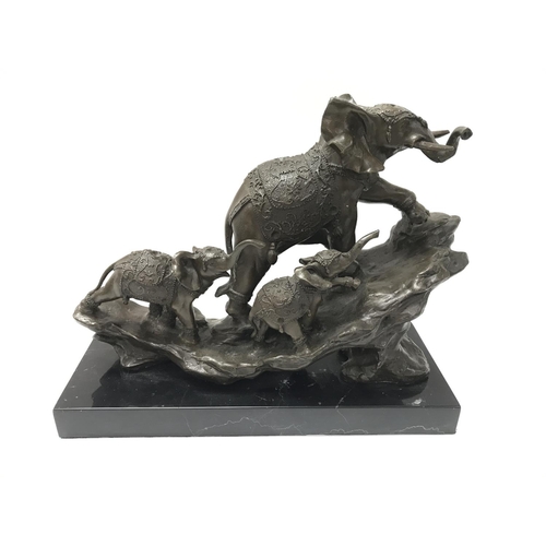 1911 - A modern cast bronze elephant figure on a stone base. 30cm wide by 25cm tall.