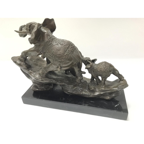 1911 - A modern cast bronze elephant figure on a stone base. 30cm wide by 25cm tall.