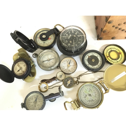 1924 - A collection of vintage compasses, military buttons, badges etc