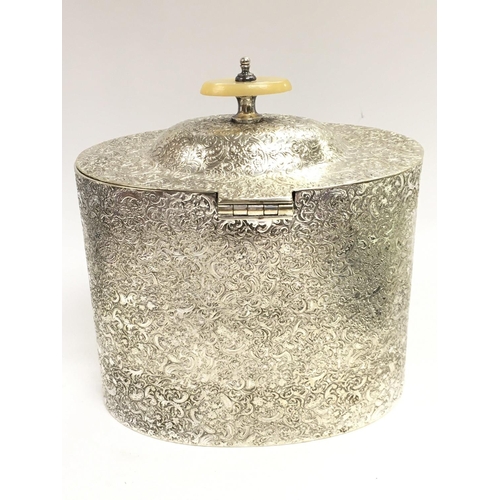 706 - An unusual silver plated tea caddy with raised decoration and mother of pearl handle, approximately ... 