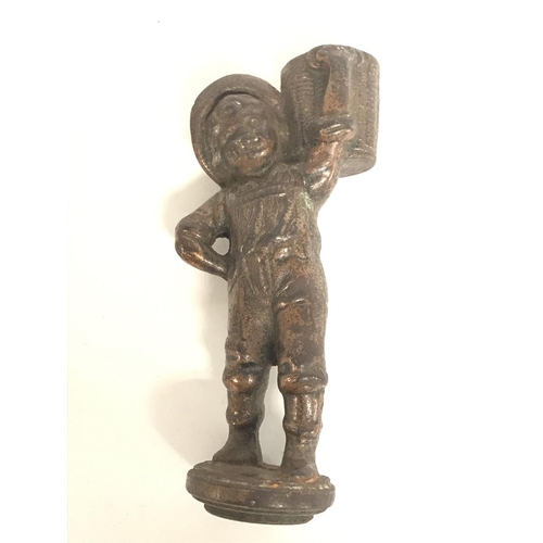 726 - A vintage cast iron bar top cigar lighter of a boy with a basket. 14cm tall. Postage category B