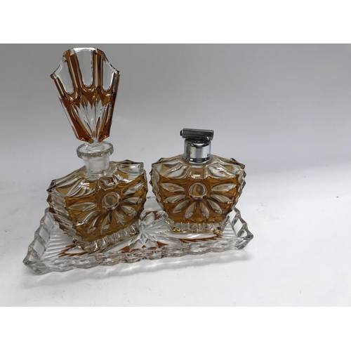 729 - A Art Deco glass perfume bottle with matching atomiser and tray .