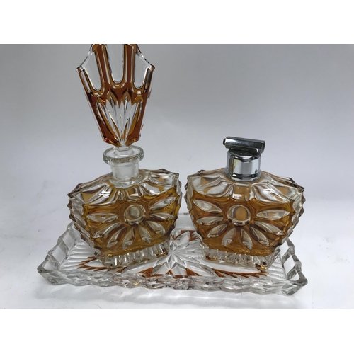 729 - A Art Deco glass perfume bottle with matching atomiser and tray .