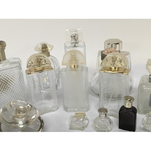 732 - A collection of quality Lalique and other designer glass scent bottles.