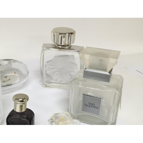 732 - A collection of quality Lalique and other designer glass scent bottles.