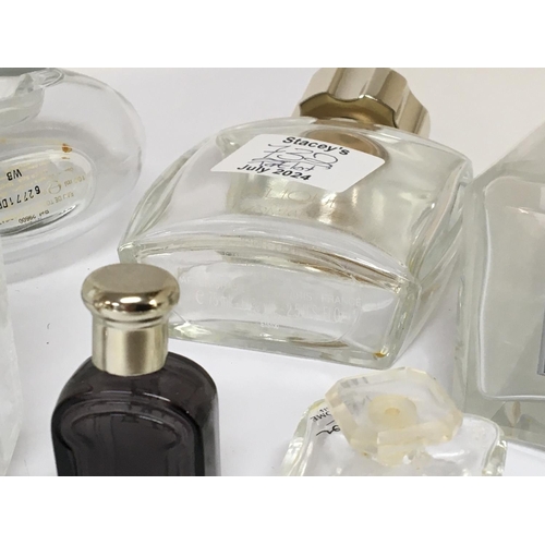 732 - A collection of quality Lalique and other designer glass scent bottles.