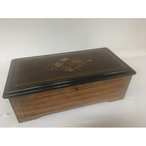 742 - A Victorian Musical box in an inlaid walnut case playing six Airs. Working and with no broken comb p... 