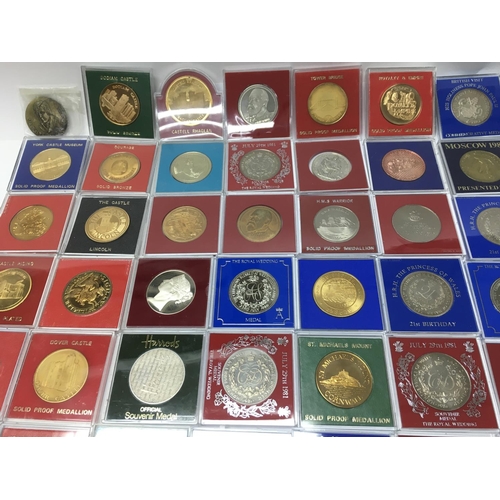 765 - A large collection of assorted commemorative medals including many 22ct gold plated examples. Postag... 